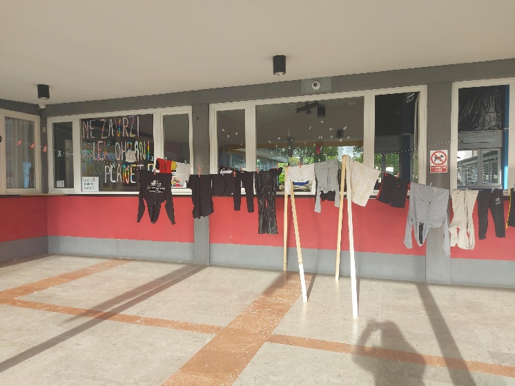 Oblačila obešena pred šolo.